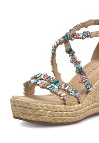 Hakensandaal met een geweven jute zool, voorzien van beige bandjes versierd met meerkleurige rhinestones en een zachte, gestructureerde binnenzool.