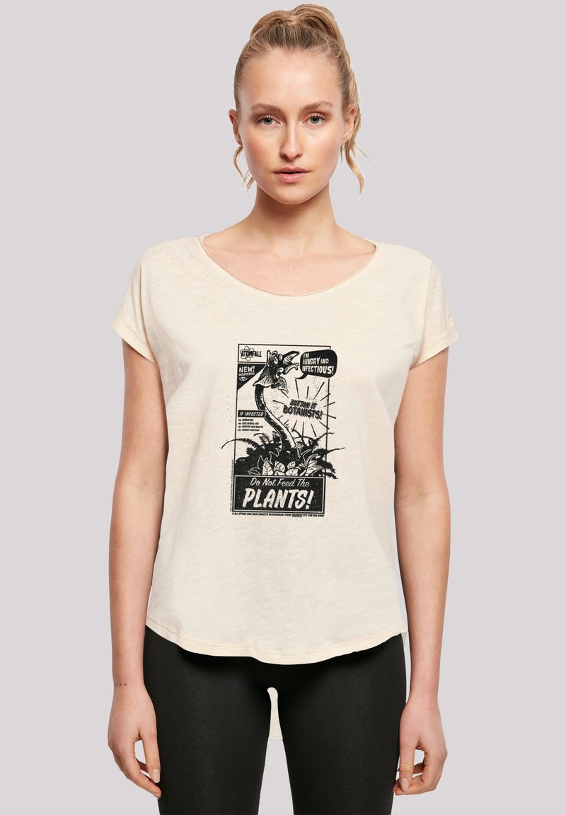 Cream-colored, short-sleeve t-shirt featuring a vintage-style black graphic print with text "Do Not Feed The PLANTS!" and a plant motif.