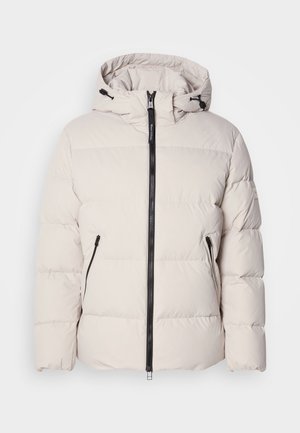 Puffer jacket in light beige, featuring a hood, front zipper, and two zippered side pockets. Textured, quilted design with elastic cuffs.