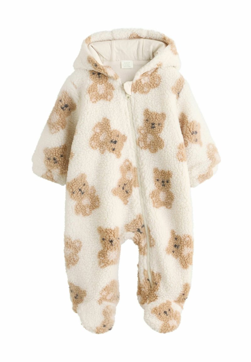 Fleece-Einteiler in Creme, mit Reißverschluss und Kapuze. Verziert mit hellbraunen Bärenmustern. Weicher Stoff, mit Füßen.