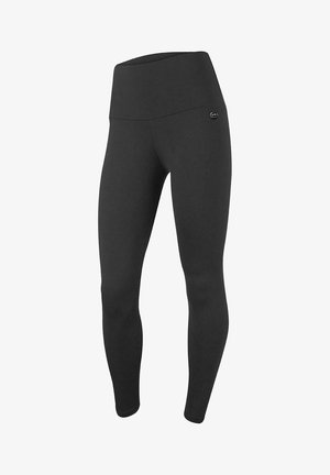 Leggings negros de talle alto para mujer con un pequeño logo circular en el muslo superior izquierdo, diseño sin costuras y longitud completa.