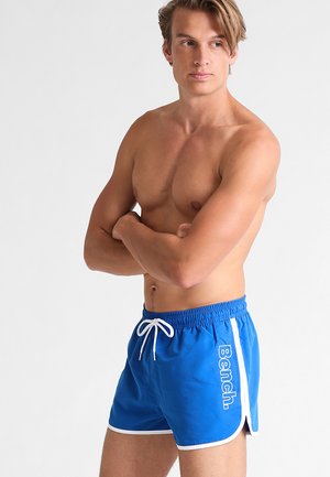 Blue swim shorts made of lightweight fabric, featuring a white drawstring and side stripes. The "Bench." logo is printed in white on the front.