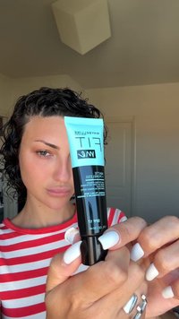 Matte primer in a black tube with a light blue cap. Text includes “Maybelline Fit,” with a label detailing skin type suitability.