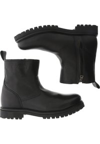 Botas de cuero negro hasta el tobillo con detalle de cremallera, suela acanalada, puntera redonda y logo grabado en la parte trasera. Textura suave con un acabado mate.