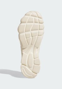 Rubber shoe sole in off-white featuring a textured design with grooves and patterns for traction and durability.