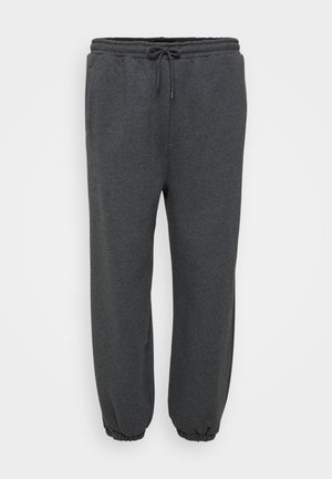 Pehmeast puuvillast valmistatud süsi hallid dressipüksid, millel on elastne vöökoht paelaga, küljetaskud ja elastsed mansetid pahkluude juures.