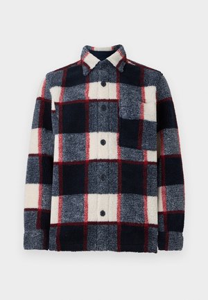 Flannel shirt featuring a plaid pattern in navy, cream, and burgundy. Textured fabric, button closure, and a chest pocket on the left.