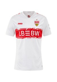 Maglietta da calcio bianca con design testurizzato, dettagli rossi e logo. Caratterizzata da un collo a giro, maniche corte e una grafica del sponsor rossa ben visibile.