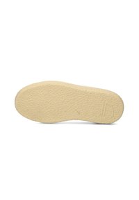 Rubber shoe sole in light beige, textured surface with a wavy pattern, featuring a subtle logo near the heel. Flat and rounded shape.