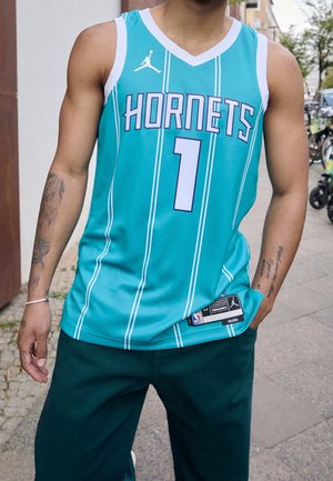 Turquoise basketball jersey with white and lavender accents, featuring vertical stripes and the text "HORNETS" and number "1." Standard fit.