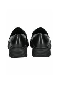 Scarpe nere in pelle a slip-on con design curvo, suole testurizzate e profilo basso. Presentano una parte superiore liscia e dettagli di cucitura sottili.