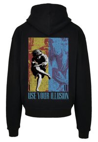 Black hoodie featuring a vibrant graphic design with yellow, blue, and red sections, depicting a figure in motion and the text "USE YOUR ILLUSION."