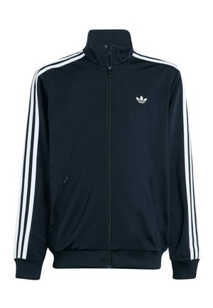 Giacca sportiva Adidas nera con zip, con tre strisce bianche sulle maniche e logo Trefoil sul petto lato sinistro.