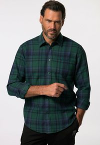 Camisa de cuadros verde y azul de botón en una tela suave. Cuenta con un bolsillo en el pecho, puños abotonados y un dobladillo redondeado.