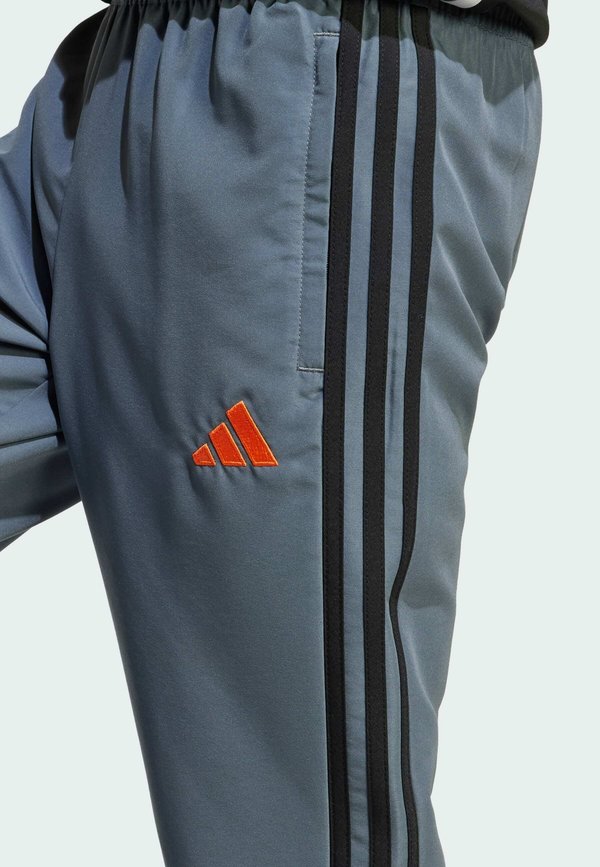 TIRO 25 ESSENTIALS WOVEN KIDS - Tracksuit bottoms - team onix super orange3