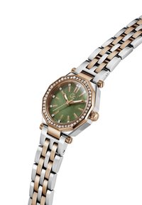 Dāmu pulkstenis ar astoņstūrainu zaļo ciparnīcu, rožu zelta akcentiem, kristāla rāmi, un sudraba/rožu zelta nerūsējošā tērauda siksnu.