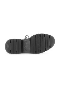 Black rubber shoe sole with horizontal grooves and textured surface, featuring "Gabor" branding and a rounded toe design.