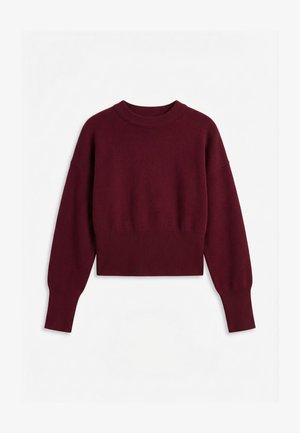 Pull court bordeaux avec manches longues, col rond côtelé, poignets et ourlet sur fond blanc.