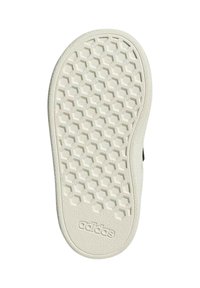 Semelle en caoutchouc blanche avec un motif hexagonal, présentant des accents texturés et un logo de marque en relief. Bout arrondi et bords latéraux.
