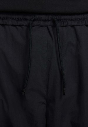 Nike Sportswear CLUB PANT - Spodnji deli trenirk - black white