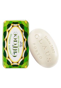 Green leaf-patterned box contains a white oval soap with embossed text. Soap label reads "Claus Porto, Since 1887."