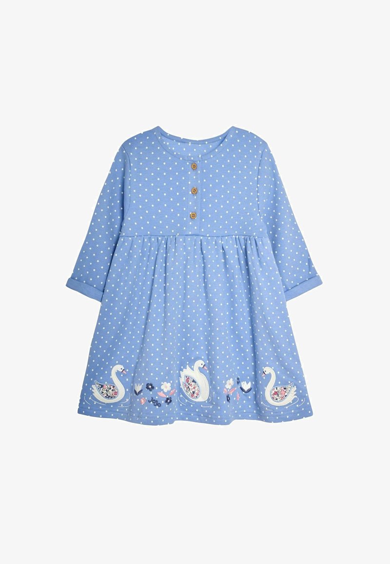 Vaaleansininen mekko, jossa on valkoisia pilkkuja, pyöreä pääntie, kolme puupainiketta sekä brodeerattuja joutsenia ja kukkakuvioita helman reunassa.