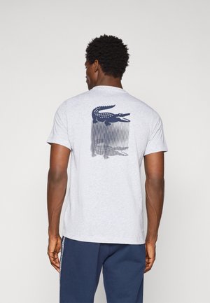 Gray cotton t-shirt with crew neck, short sleeves, featuring a navy crocodile graphic on the back above vertical line patterns.