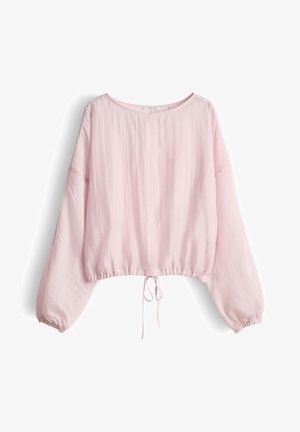 Blouse rose clair à manches longues, coupe ample, col rond, poignets élastiques et ourlet à cordon, sur fond blanc.