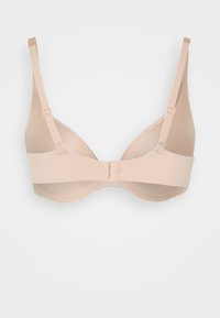 Beige bh med bøjler og justerbare stropper, en glat tekstur og en klipslukning bagpå. Enkel design og sømløse skåle.