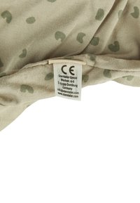 Beige fabric hat with small green heart-patterns. Includes a care label with CE mark and brand details sewn into the interior.