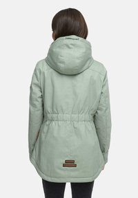 Mint green jacket with a cinched waist, drawstring hood, and brown accent patches. Smooth texture and hip-length design.