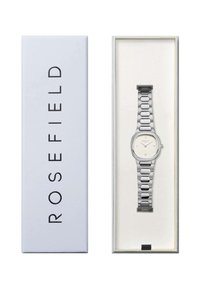 Reloj de acero inoxidable plateado con una cara rectangular, esfera blanca, marcadores de horas y diseño de pulsera vinculada, presentado en una caja blanca.
