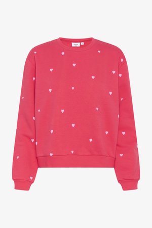 Punane sviiter ümmarguse kaelusega, millel on väiksed roosa südame mustrid, mis on ühtlaselt jaotatud kogu pinnale. Valmistatud pehmest kangast.