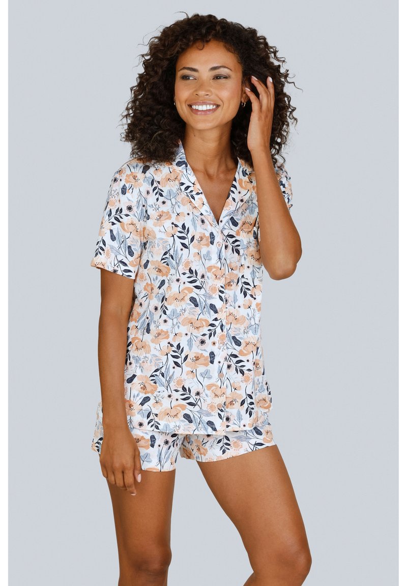 Floral short-sleeve pajama set in white, featuring peach flowers and dark leaves. Soft fabric with a collar and matching shorts.