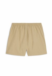 Beige, leichte Shorts mit einem elastischen Bund, die eine glatte Textur und eine lockere Passform aufweisen. Keine sichtbaren Taschen oder Muster.