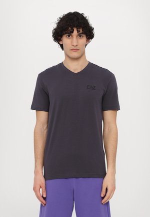 Dark gray v-neck t-shirt made of soft cotton, featuring short sleeves and a small black logo on the chest. Simple, minimalist design.