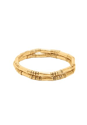Złota bransoletka z teksturowanymi cylindrycznymi segmentami połączonymi ozdobnymi pierścieniami, tworząca ciągłą pętlę na białym tle.
