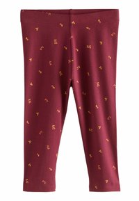 Burgundy leggings i mjukt tyg med ett spritt mönster av gula och röda prickar. Stretchigt midjeband och figurnära längd vid anklarna.