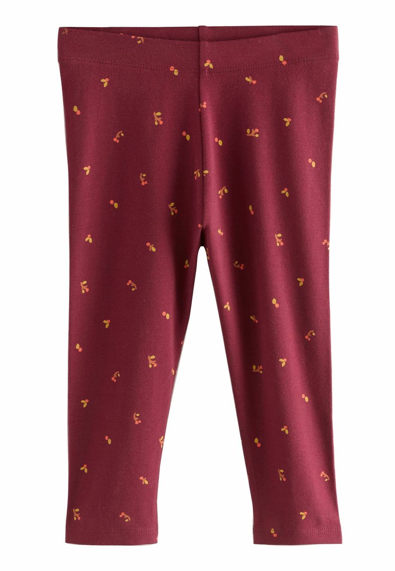 Burgundy leggings i mjukt tyg med ett spritt mönster av gula och röda prickar. Stretchigt midjeband och figurnära längd vid anklarna.
