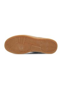 Suola di una sneakers, realizzata in gomma gommosa testurizzata con un motivo circolare e profonde scanalature per una migliore aderenza.