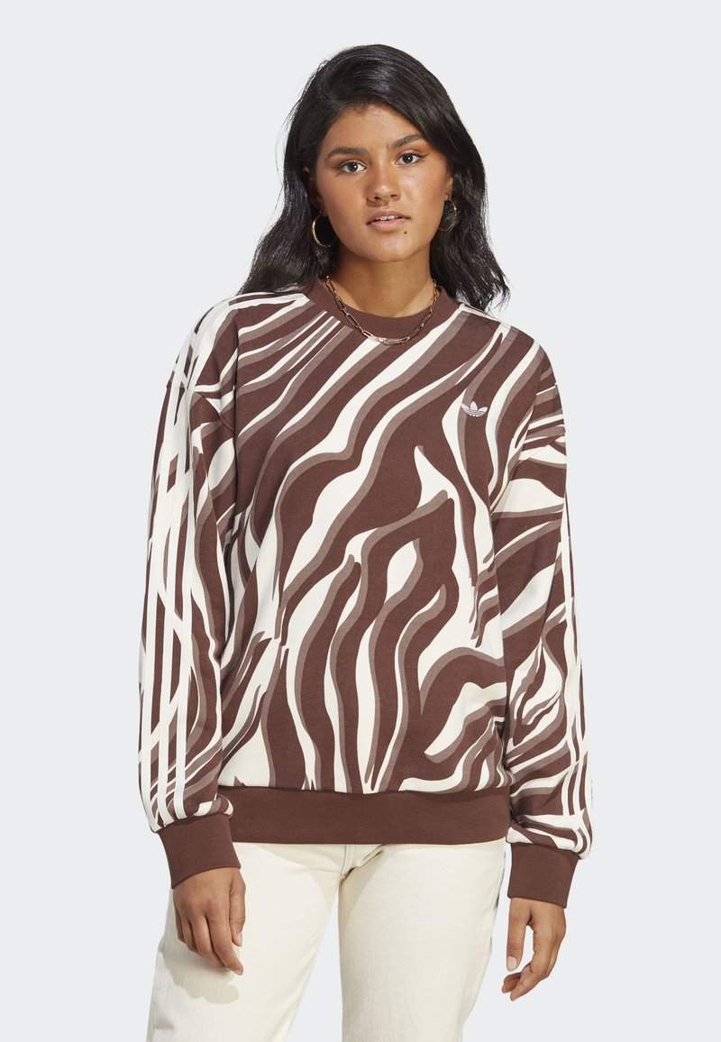 Sweatshirt às riscas castanho e creme, feito de um tecido suave, apresentando um decote redondo e punhos canelados. Logótipo subtil no peito.