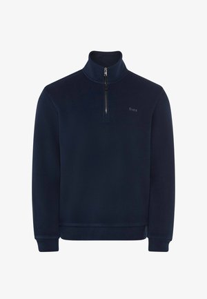 Pullover in pile navy con colletto alto, zip frontale a quarto, polsini a coste e un logo discreto. Texture liscia e vestibilità rilassata.