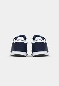Navy blue sneakers with a smooth texture, featuring white accents on the heel and midsole, and a branding logo on the back.