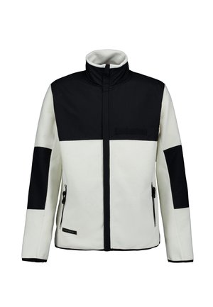 Chaqueta negra y blanca con cremallera, cuello alto, parches negros en los hombros y codos, y bolsillos laterales con cremallera.