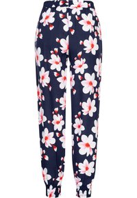 Pantaloni della tuta floreali navy con elastico in vita, caratterizzati da grandi fiori bianchi e rosa, polsini arricciati e un tessuto liscio e leggero.