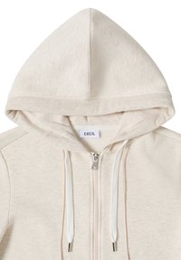 Sweat à capuche beige avec fermeture éclair, cordons de serrage, bordure de capuche côtelée et étiquette de marque "CECIL" à l'encolure.