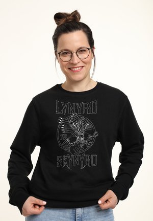 Felpa nera con un design grafico che presenta un'aquila e una chitarra. Polsini e colletto a costine, realizzata in tessuto misto cotone.