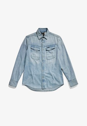 Lyseblå cowboyskjorte med lange ærmer, knaplukning foran, to brystlommer og klassisk krave. Blød tekstur med et afslappet design.