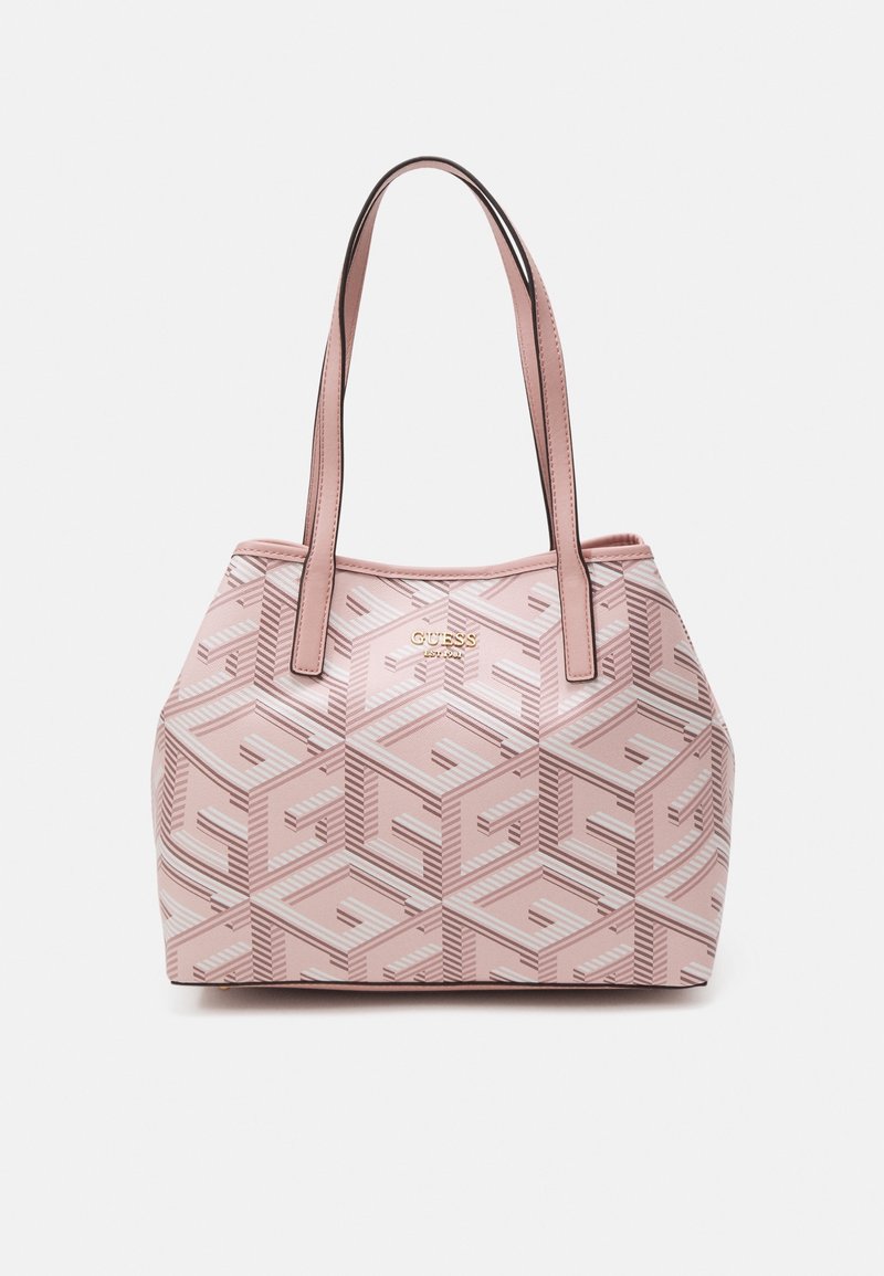 Sac cabas rose avec double bretelle et un motif géométrique présentant le logo Guess en design répétitif, nom de la marque doré sur le devant.