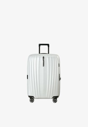 White hard-shell suitcase with black retractable handle and four spinner wheels, standing upright on a white background.